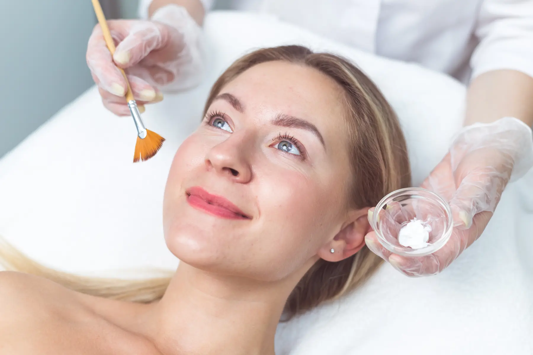 beautician-applying-facial-mask-to-the-young-lady-2026-03-09-01-51-46-utc