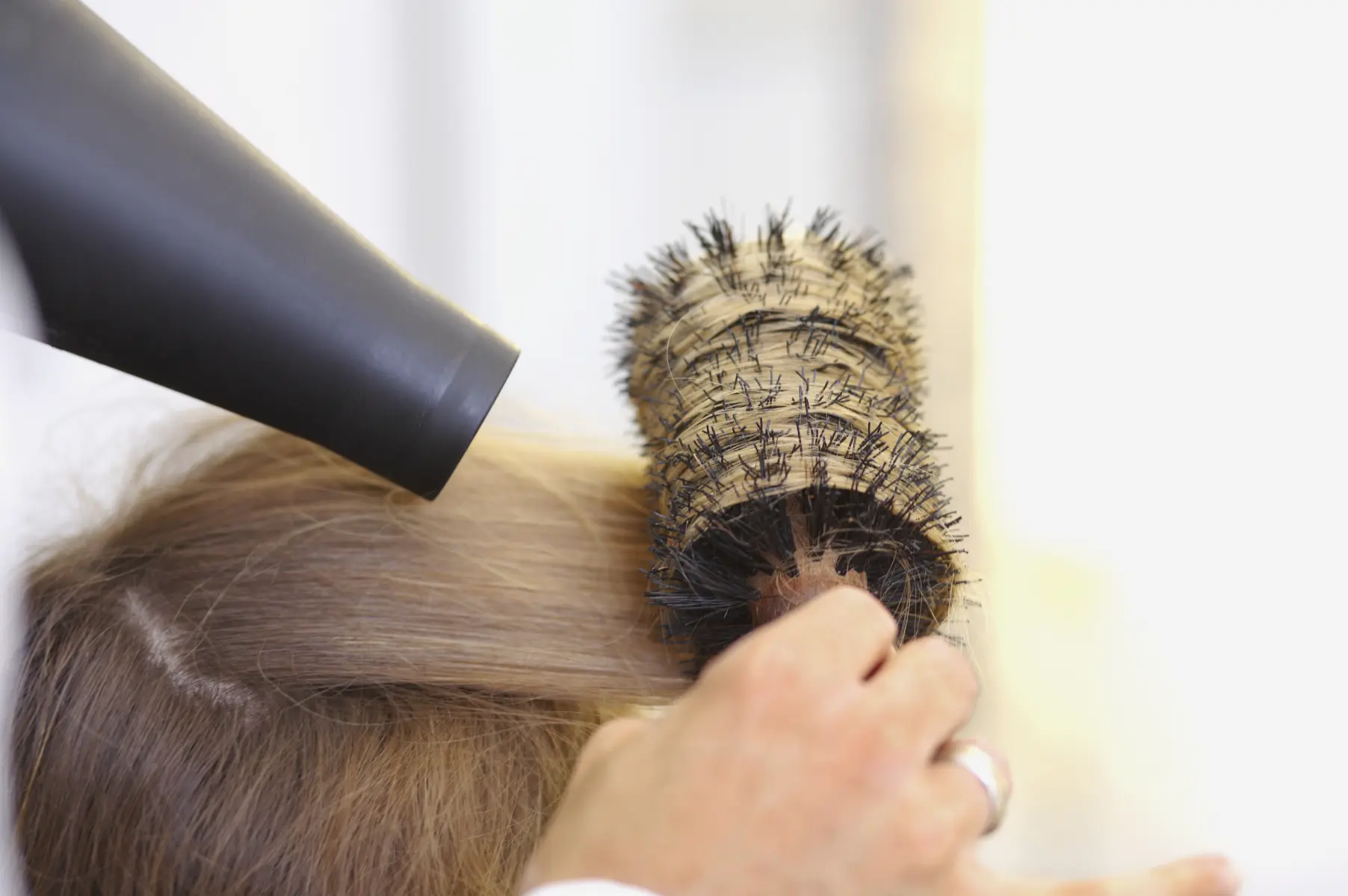 close-up-of-hair-stylist-blowdrying-client-s-hair-2026-03-26-09-10-41-utc