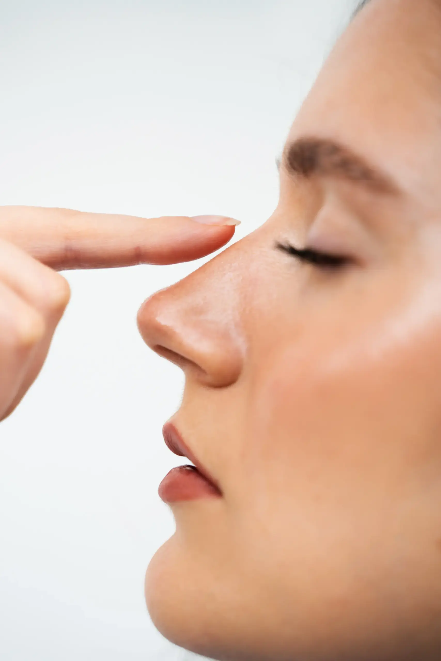 closeup-rhinoplasty-reshape-nose-improve-breathing-attractive-girl-touches-her-nose-before-septoplasty