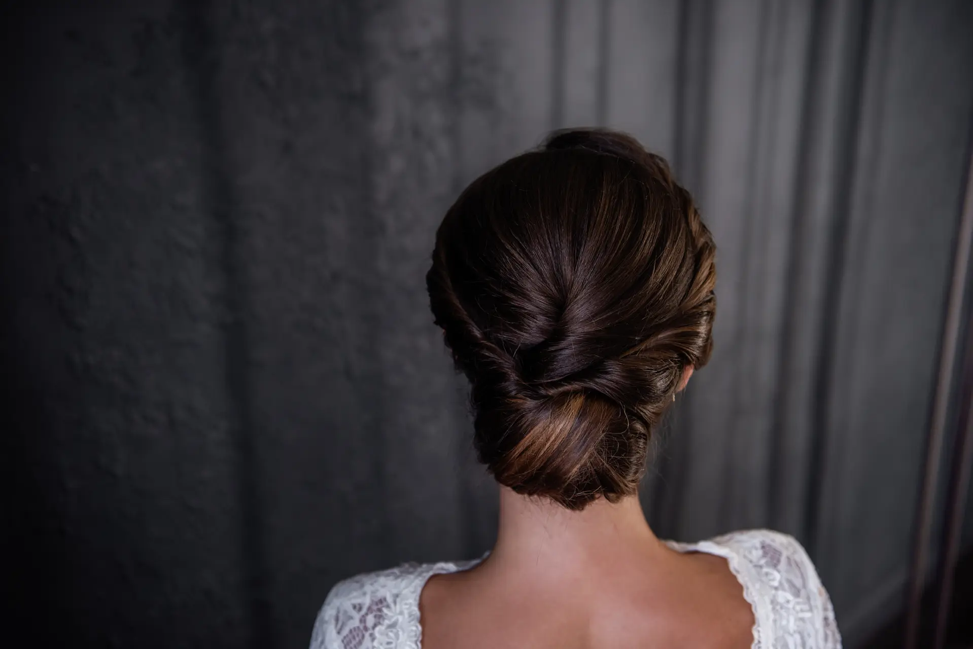 elegant-hairstyle-with-dark-hair-against-grey-back-2026-01-08-23-40-47-utc