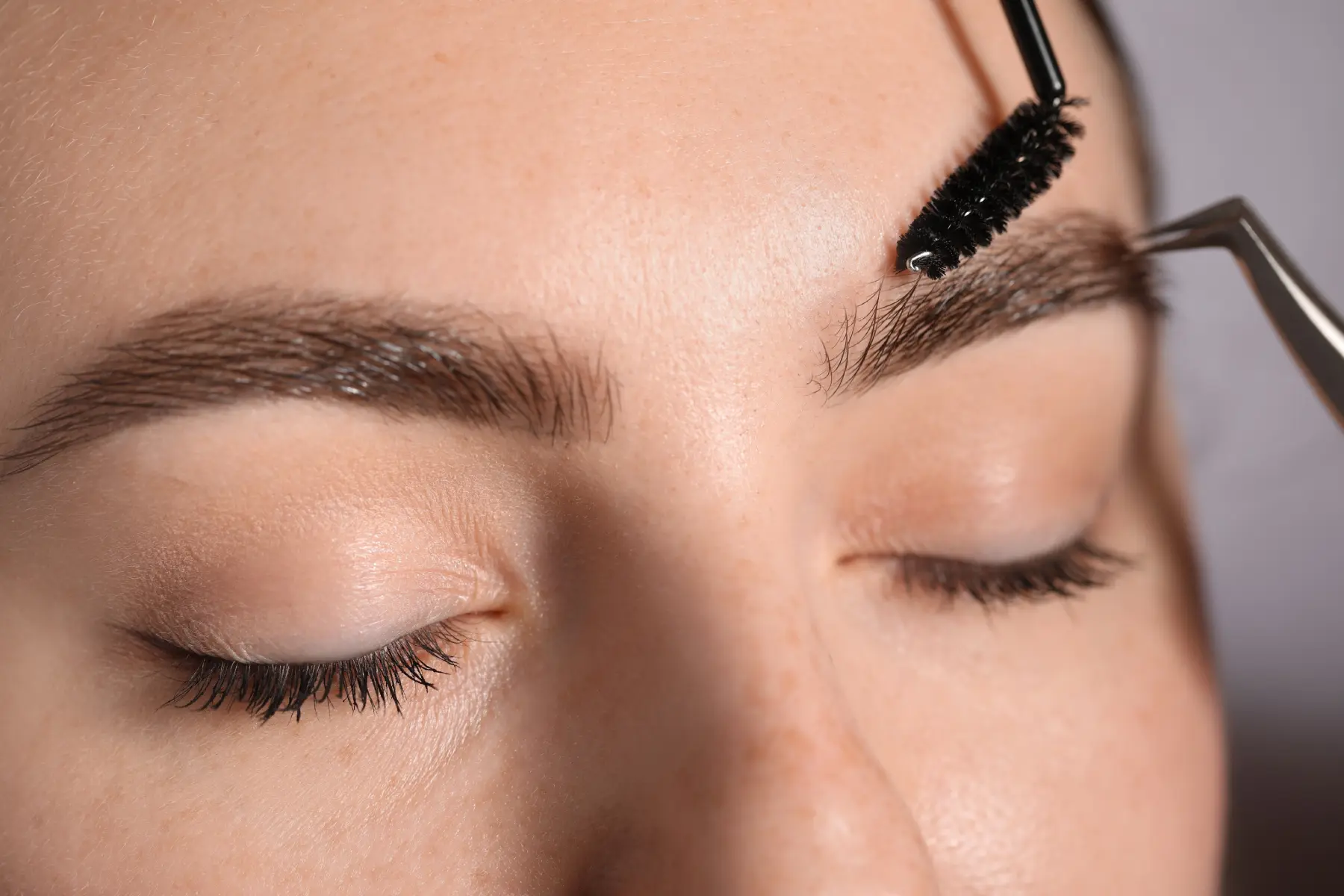 extreme-close-up-of-woman-having-her-eyebrows-brus-2026-06-16-06-28-59-utc