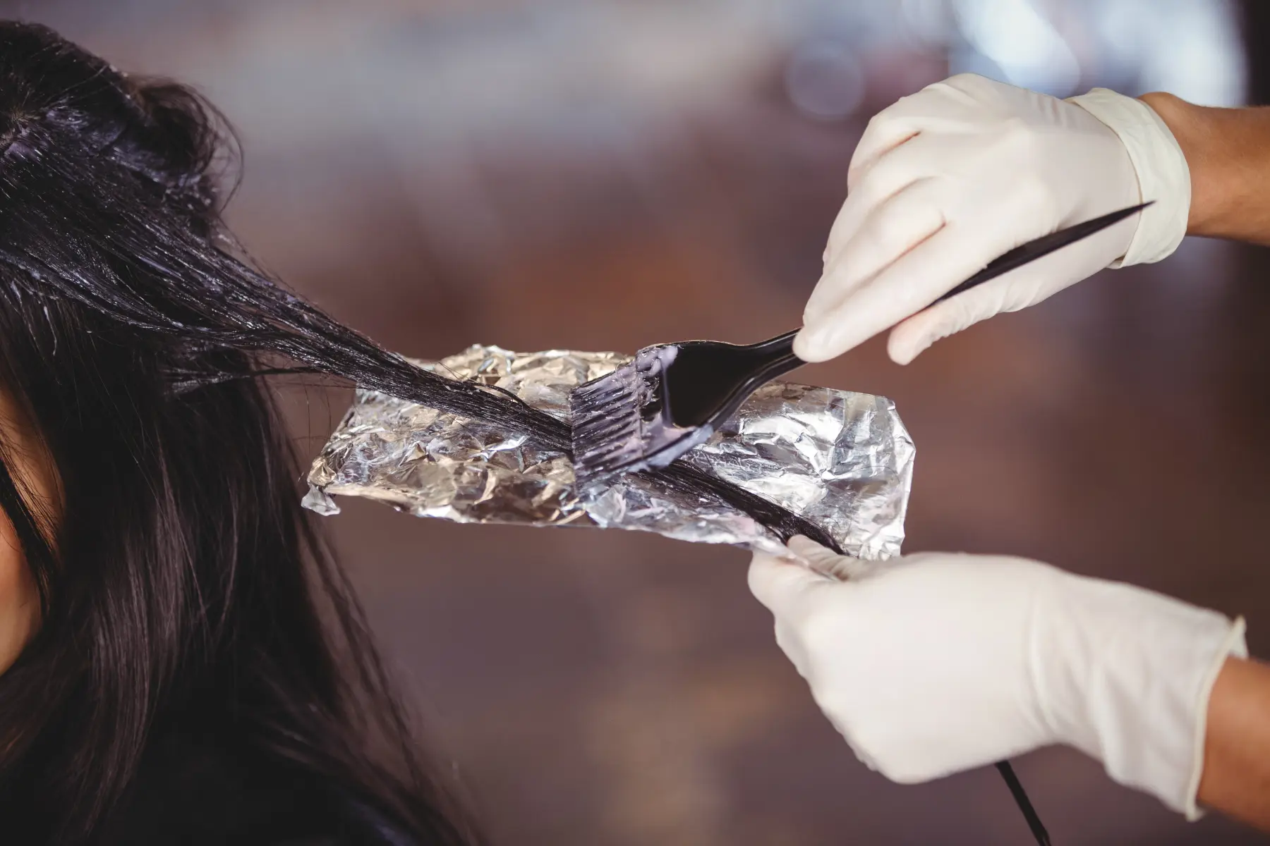 hairdresser-applying-dye-to-a-woman-s-hair-2026-03-25-00-53-32-utc