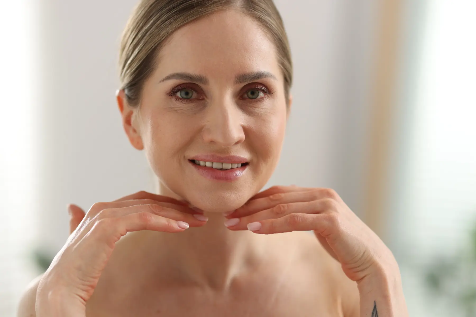 smiling-woman-touching-her-neck-in-a-beauty-routin-2026-05-26-18-49-14-utc