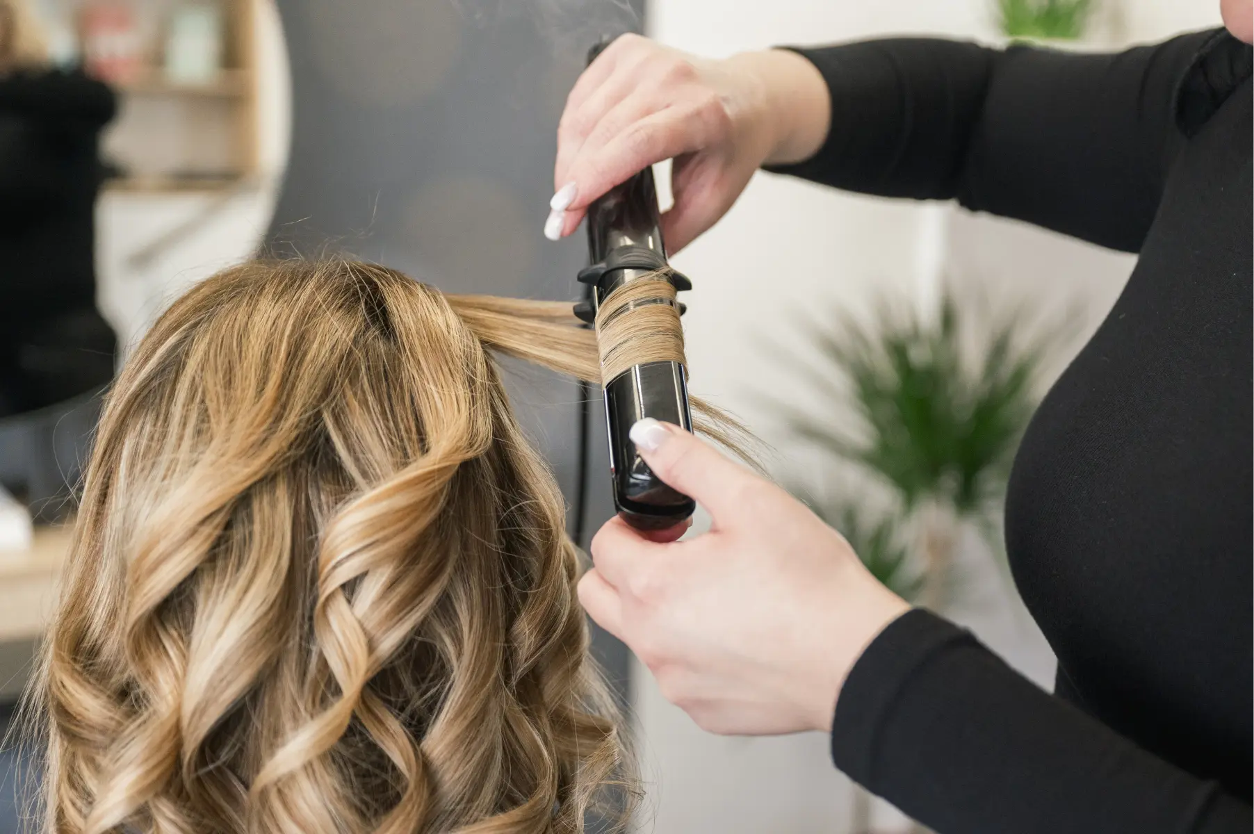 stylist-curls-blonde-hair-with-professional-tool-2026-03-25-09-14-06-utc