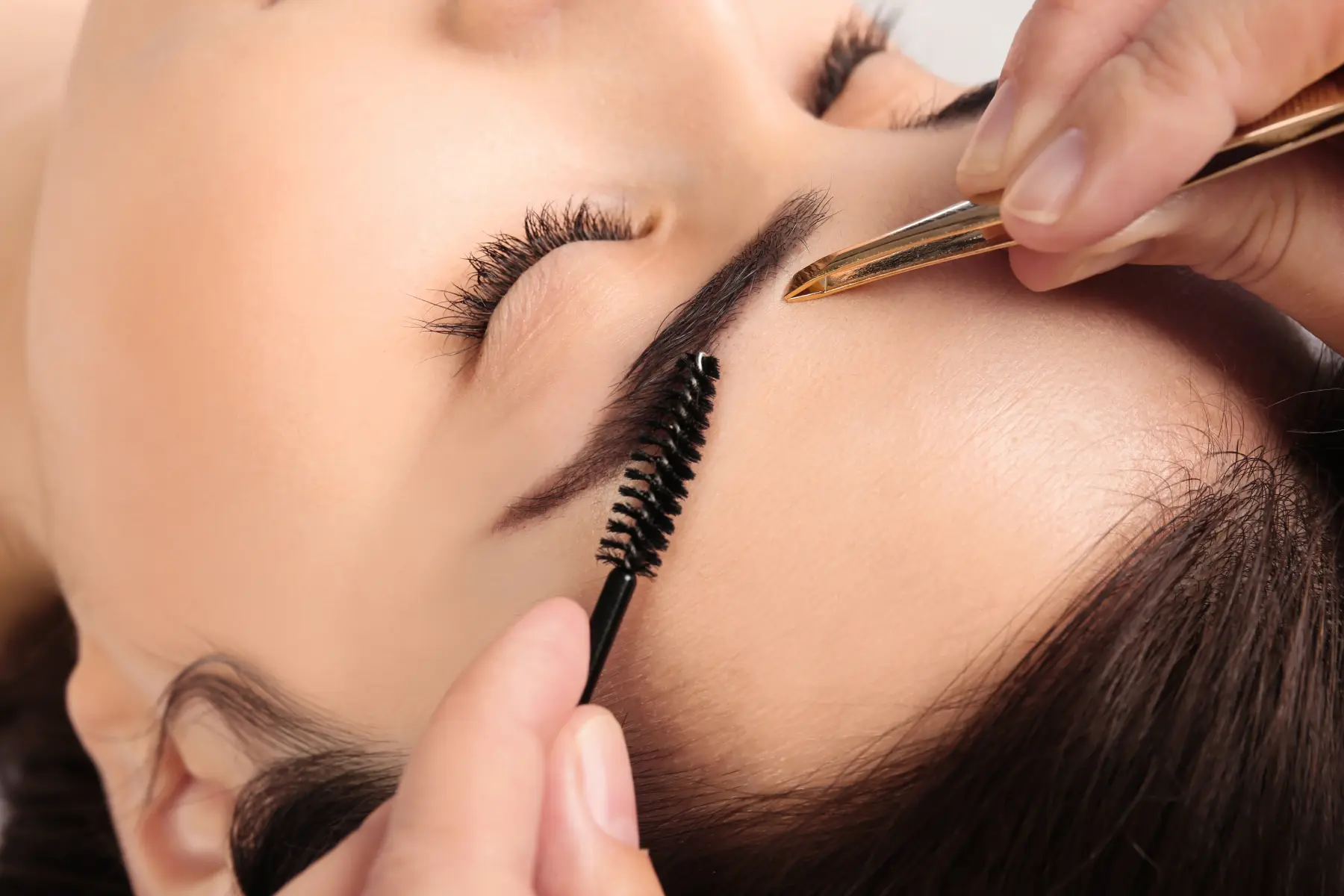 woman-getting-eyebrow-shaping-with-brush-and-tweez-2026-03-27-01-43-23-utc
