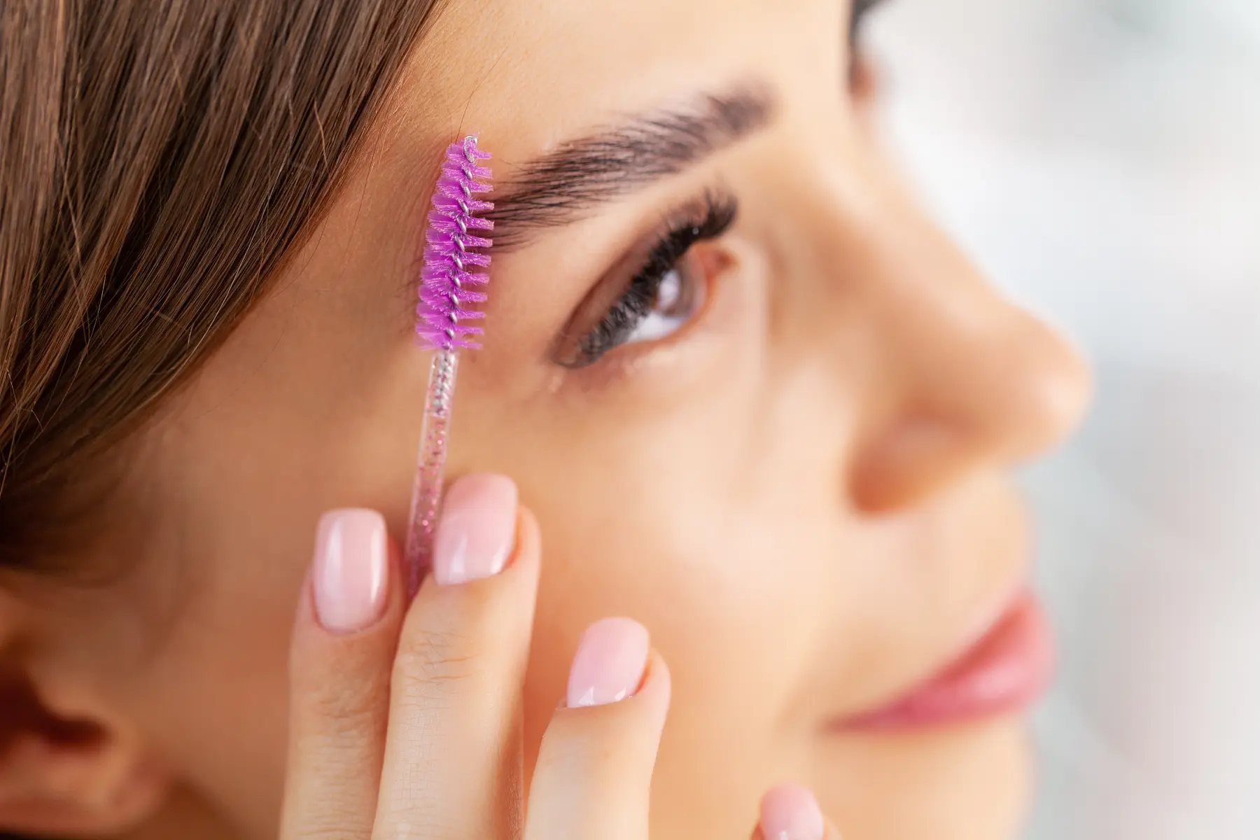 woman-grooming-eyebrow-with-purple-makeup-brush-2026-03-19-02-59-37-utc