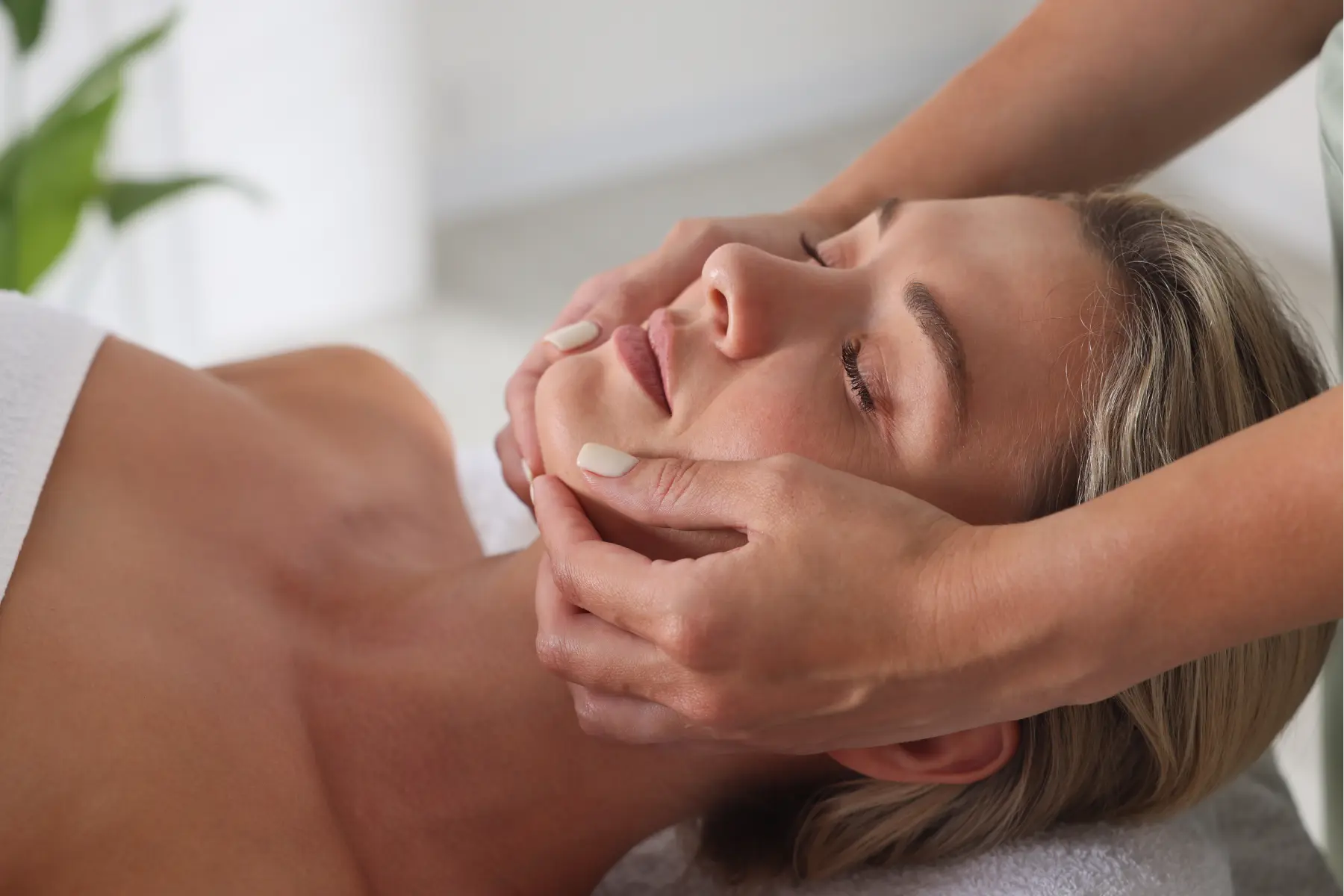 woman-receiving-a-relaxing-facial-massage-in-a-bri-2026-05-07-20-12-53-utc