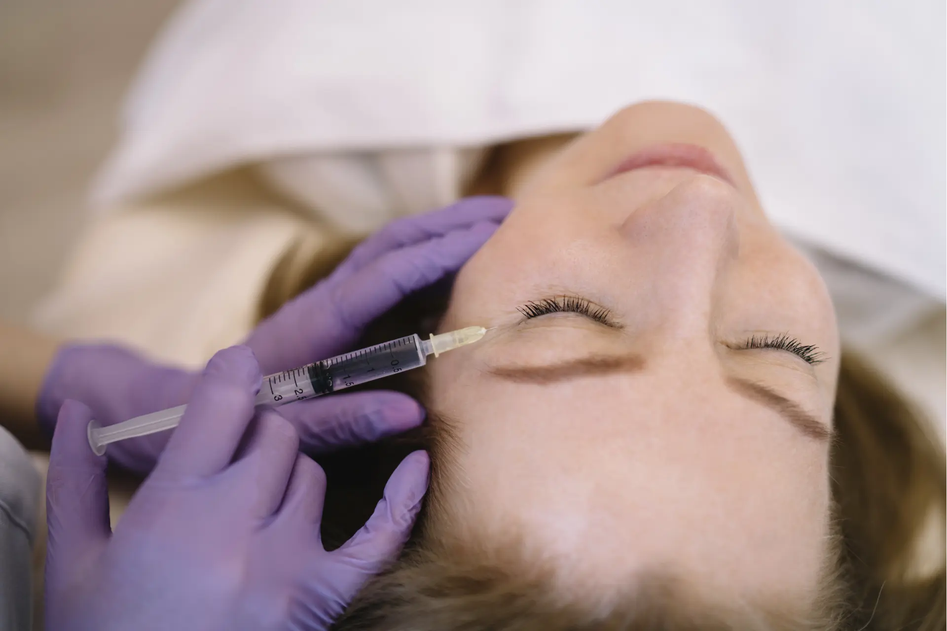 woman-receiving-cosmetic-injection-in-face-close-2026-03-24-15-46-46-utc