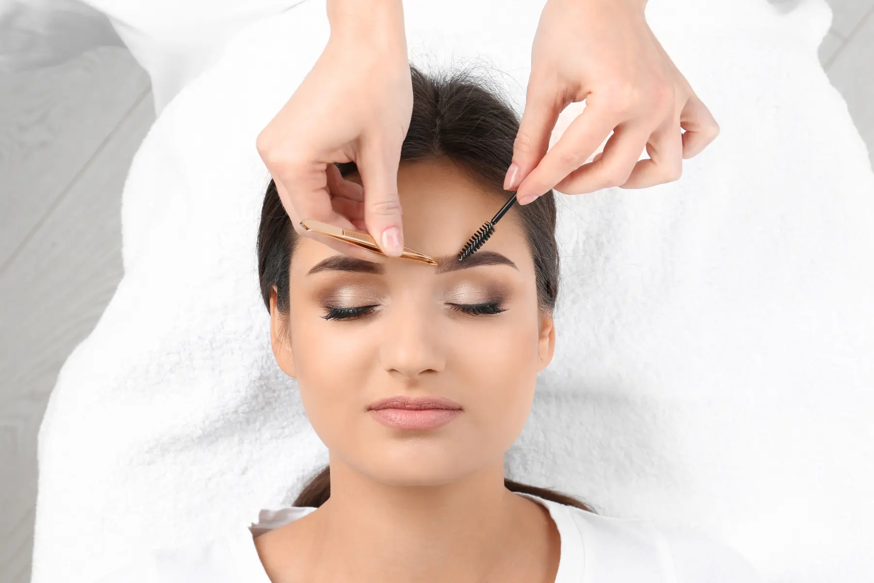 woman-receiving-eyebrow-treatment-with-brush-and-t-2026-03-27-01-20-49-utc