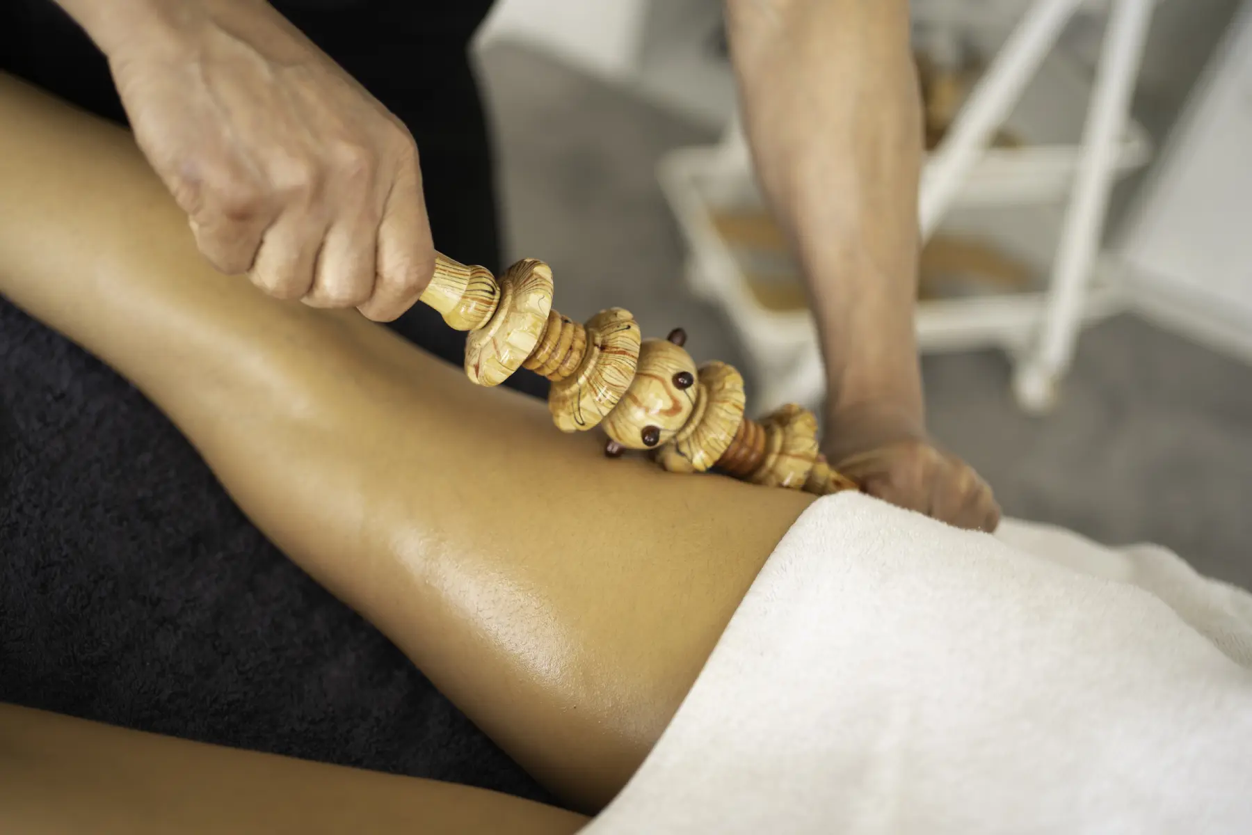 woman-receiving-massage-on-her-leg-with-roller-2026-01-09-10-12-09-utc
